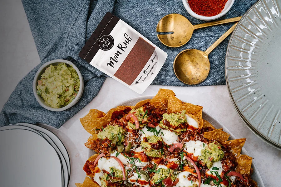 plate of nachoes, guacamole and pack of beef rub