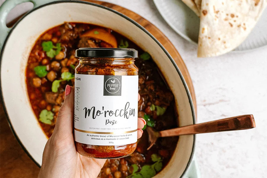 hand holding moroccan paste over stew