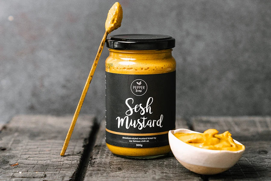 glass jar of mustard with spoon