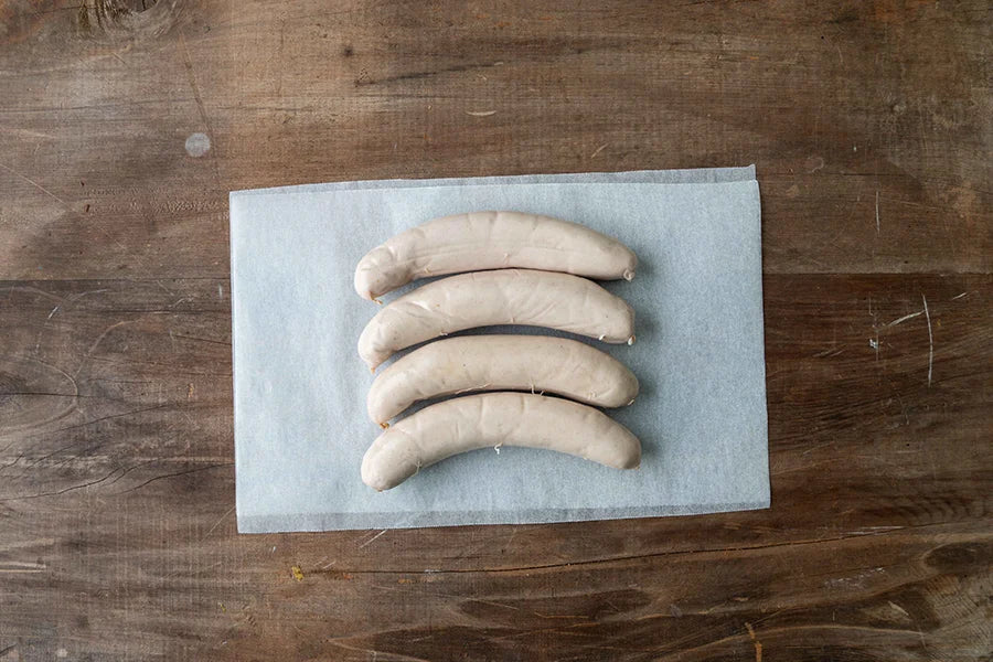 four raw veal sausages