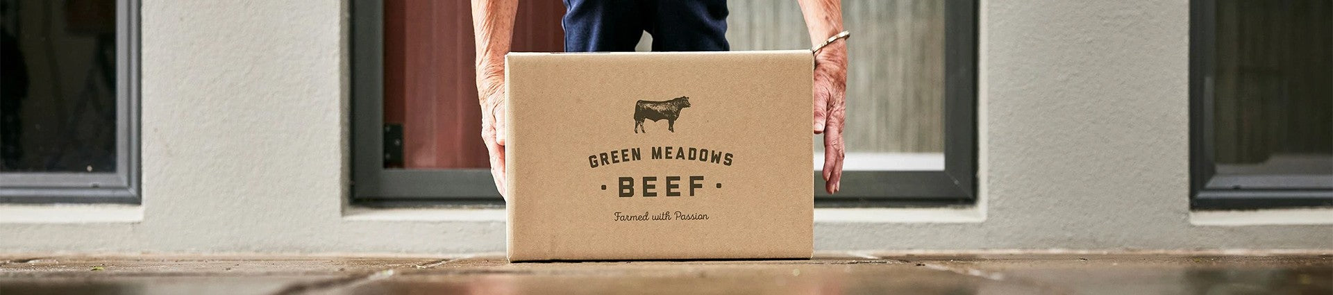 hands picking up meatbox