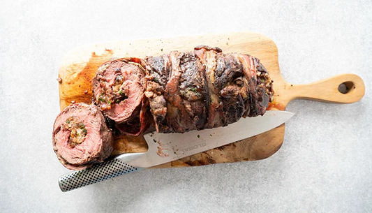 Rolled flat iron steak on board