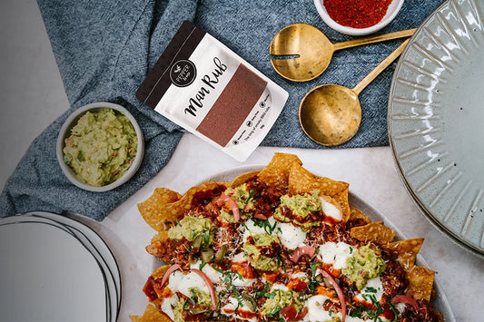 plate of nachoes, guacamole and pack of beef rub