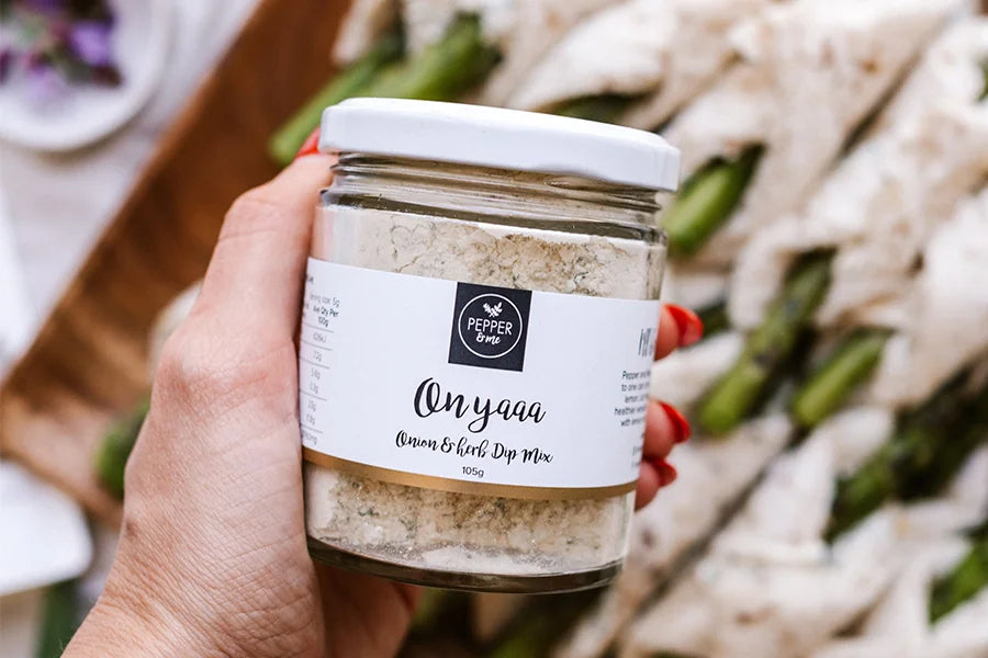 hand holding jar of onion dip mix 