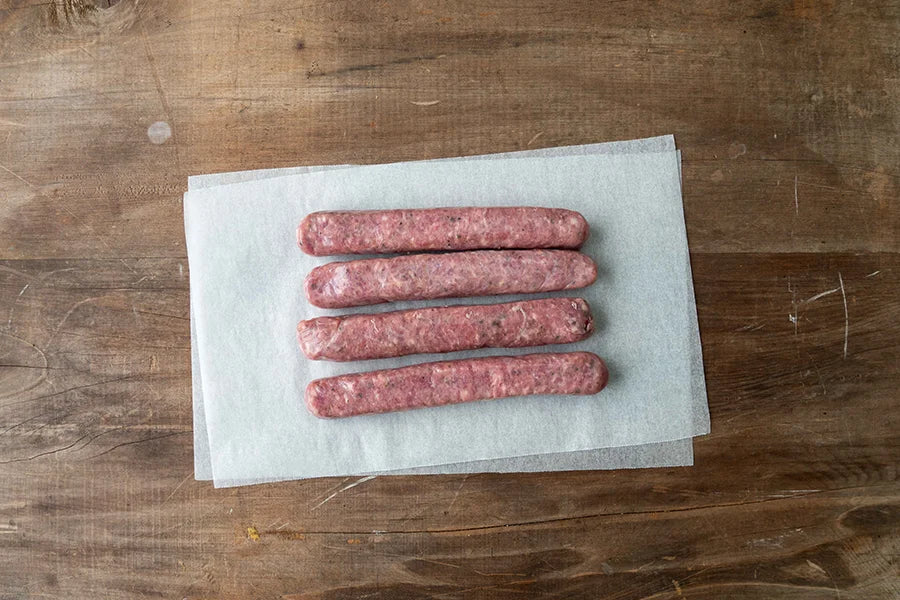 4 sausages on baking paper 