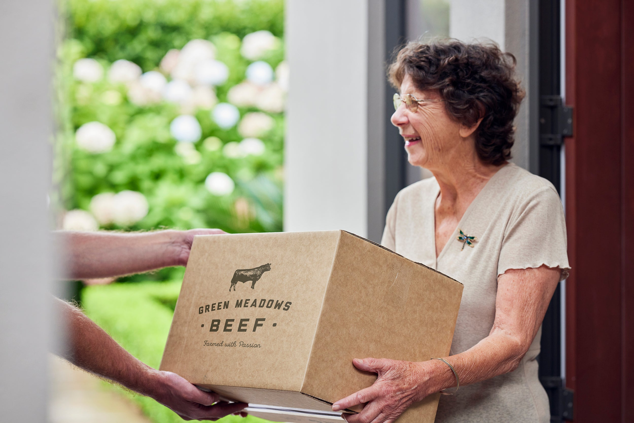 Female receiving meatbox at the door